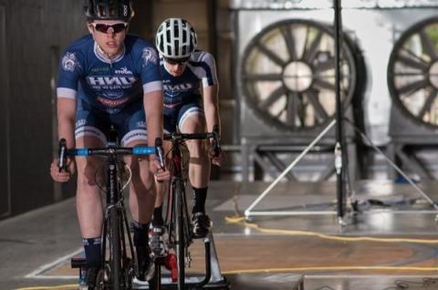 Two people riding bicycles in Flow Physics Facility